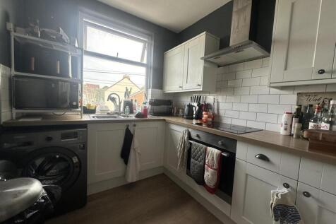 Modern kitchen with subway tiles and natural li...