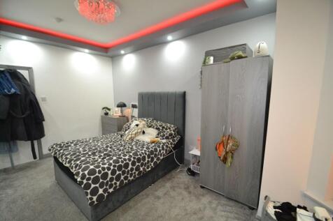 Contemporary double bedroom with a plush uphols...