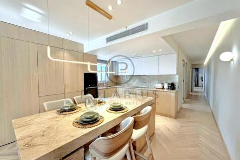Modern kitchen with light wood finishes, featuring