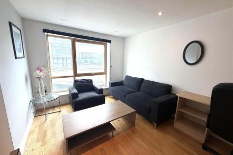 Bright modern lounge with large window and sofa...