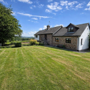 Country bungalow with vibrant lawn.png