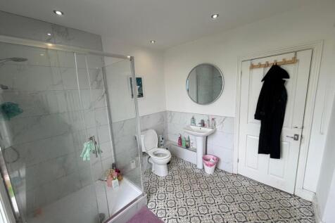 Bright bathroom with stylish patterned flooring...