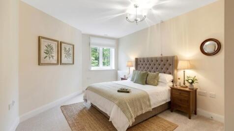 a bedroom with a bed and lamps