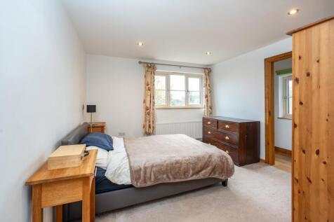 A spacious, airy double bedroom at the rear of the