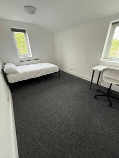 Bright and inviting double bedroom featuring la...