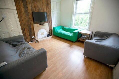 Bright communal lounge with wood flooring...