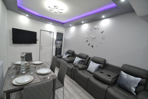 Modern living room featuring a large, comfortab...