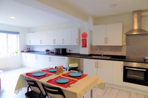 Bright and spacious kitchen with modern white c...