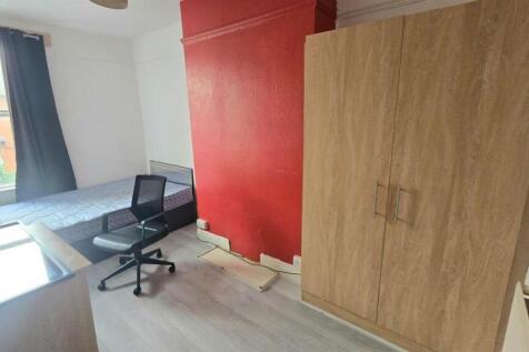 Bright, simply furnished bedroom with a large w...