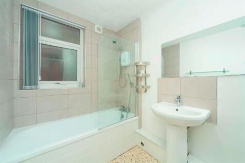 Bright bathroom with bath and shower...