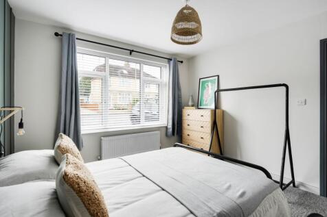 Bright, neatly styled double bedroom with a lar...