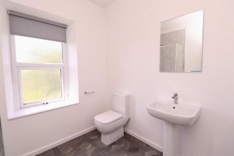 A clean and modern bathroom featuring a bright ...