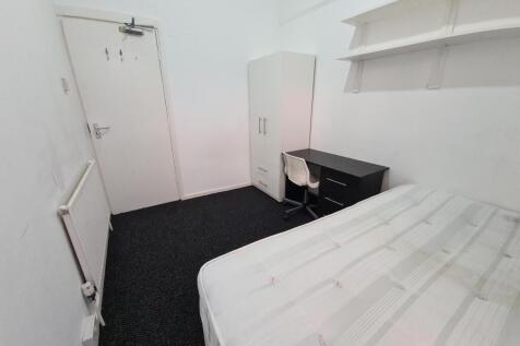 A tidy and well-maintained bedroom with a comfo...