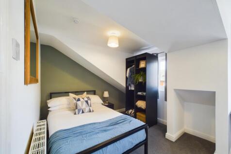 A spacious and well-maintained bedroom with a l...