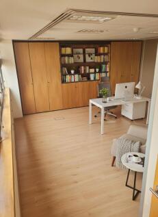 Bright, modern communal workspace with large bu...