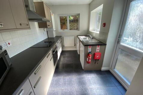 A modern and well-lit kitchenette with ample co...