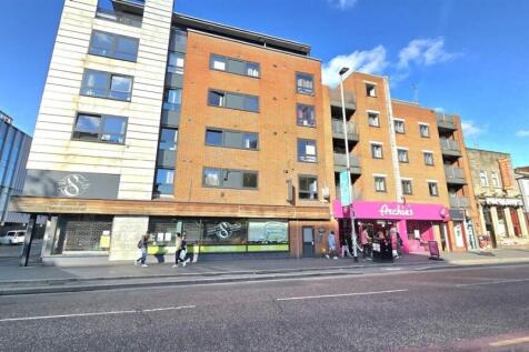 Modern apartment complex on a vibrant high stre...