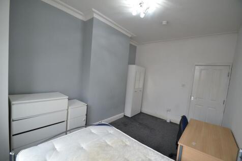 A clean and bright student bedroom featuring a ...