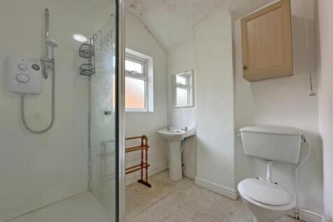Bright bathroom with walk-in shower enclosure...