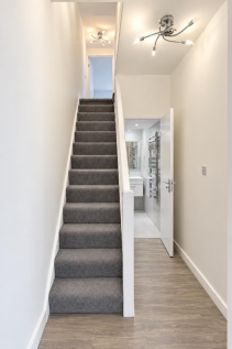 Modern Hallway with Carpeted Staircase.png
