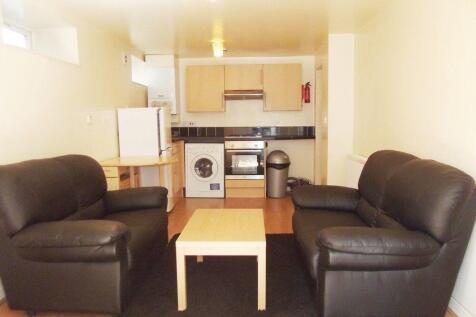 Social living area with comfy sofas and kitchen...