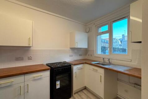 Bright modern kitchen with wooden worktops...