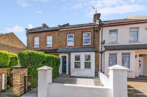 Charming terraced house with neat paved garden...