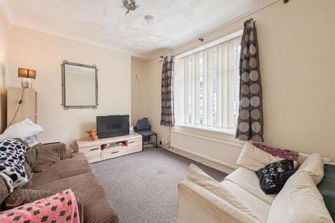 Bright lounge with large windows and cozy sofas...