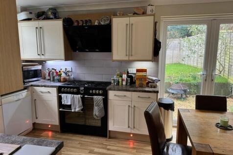 Bright, modern kitchen with a large range cooke...