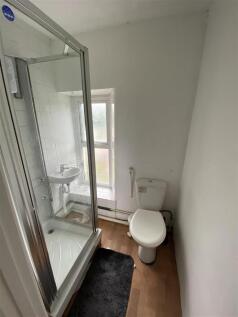 Bright bathroom with modern glass shower cubicl...