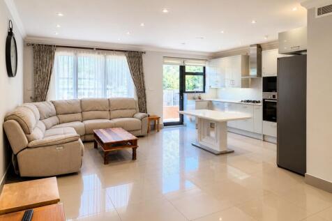 Bright, modern open-plan living and kitchen are...