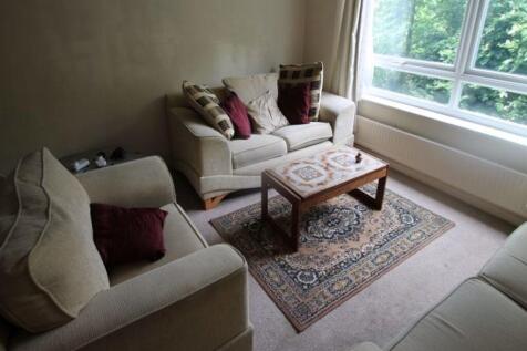 A bright and spacious living room featuring lar...