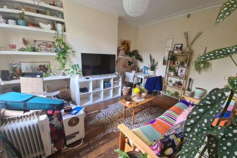 A spacious and welcoming living room filled wit...