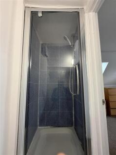 Enclosed shower cubicle with tiled walls...