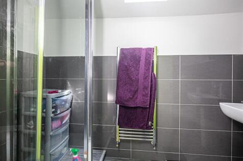 Modern tiled bathroom with heated towel rail...