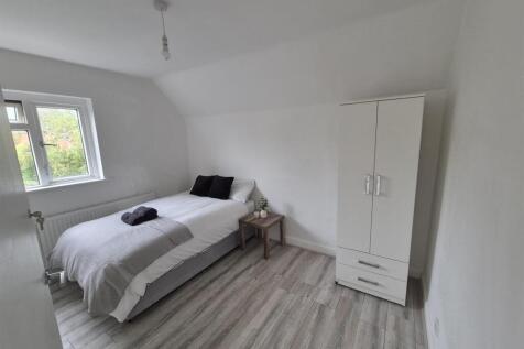 Bright bedroom with wardrobe and wood-style flo...