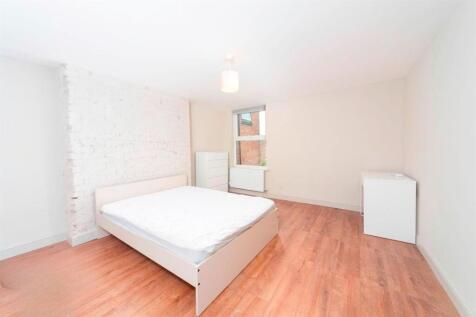 Bright, clean bedroom with wood floors...