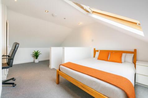 Bright and spacious master bedroom featuring a ...