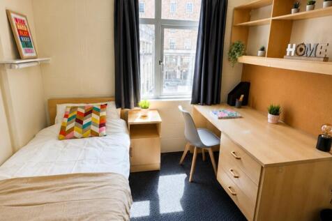 Bright study area with large desk and shelving...