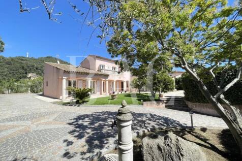 A charming house with a tiled roof is surrounded b