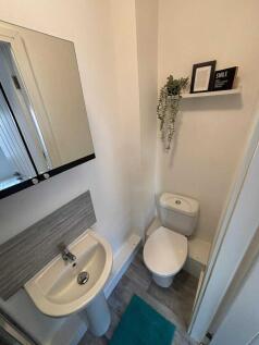 Bright and clean modern bathroom with a white t...