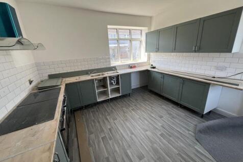 Bright and spacious kitchen featuring modern ca...