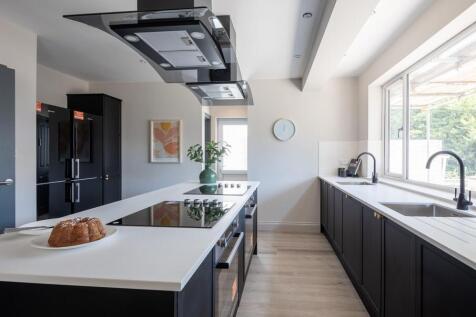 Ultra-modern kitchen with sleek island and ligh...