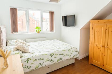 A bright and inviting double bedroom featuring ...