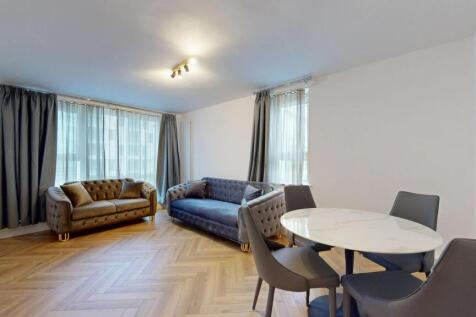 Elegant living space with plush sofas and dinin...