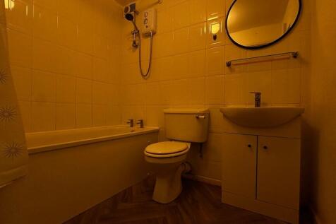 Clean bathroom suite with full tub and vanity...