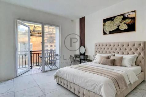 Bright and airy bedroom with a balcony overlooking
