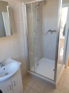 Modern shower cubicle with sleek tiling...