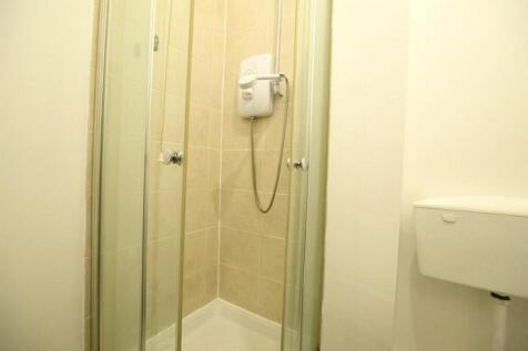 Bright bathroom with a modern walk-in shower...