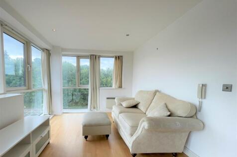 Bright lounge with large windows and comfy sofa...